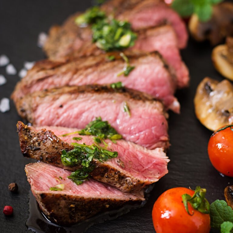 Juicy steak medium rare beef with spices and grilled vegetables.